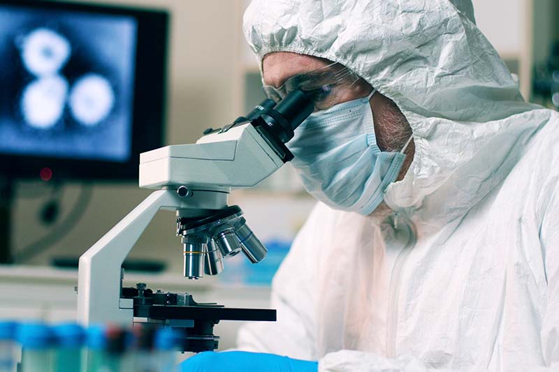 scientist using microscope